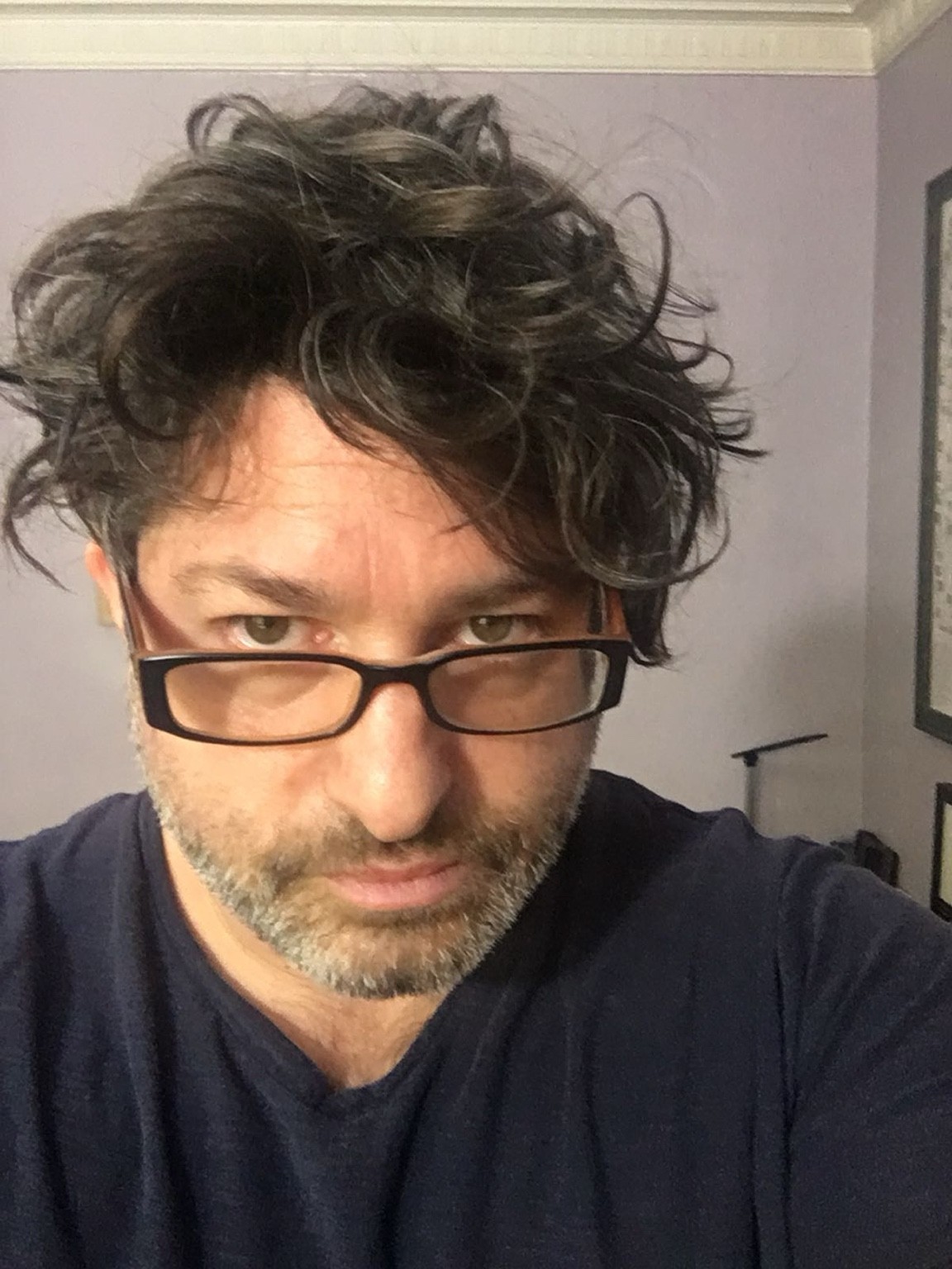 Casual earlier portrait of Ronan David in glasses.