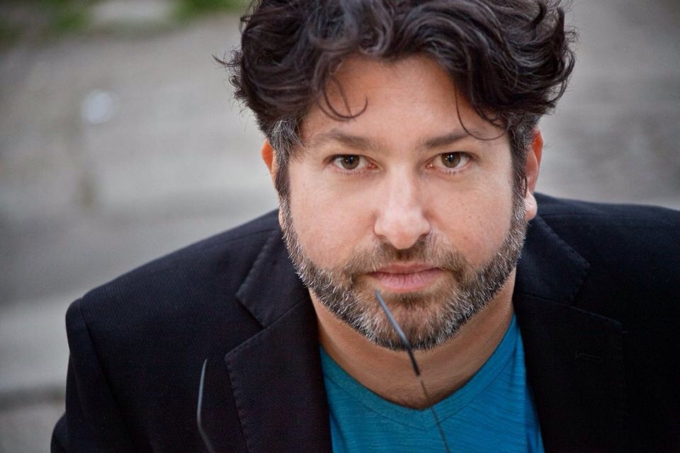 Earlier professional headshot of Ronan David.