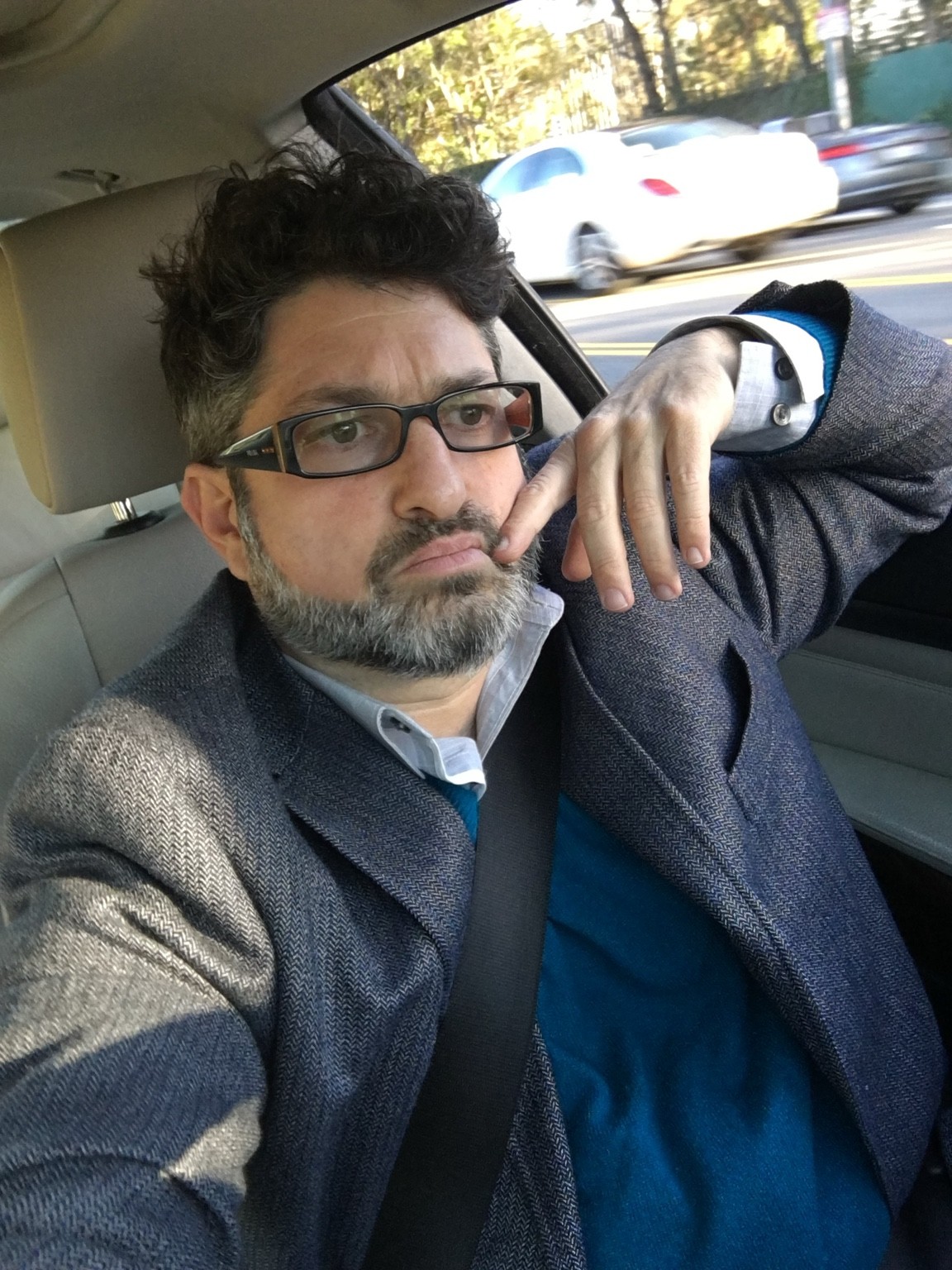 Ronan David in glasses and an overcoat.
